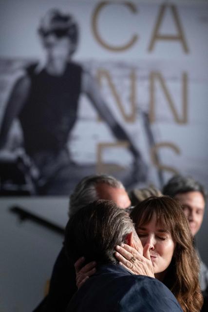 US actress Rosemarie DeWitt (C) and US director, screenwriter, actor and producer Andy Garcia (L) embrace during a press conference for the film "Diamond" at the 79th edition of the Cannes Film Festival in Cannes, southern France on May 20, 2026. (Photo by Anna KURTH / AFP)