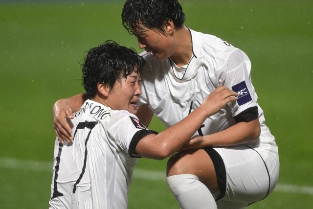 Kim Kyong Yong (L) of Naegohyang Women's FC celebrates scoring her team's second goal with a teammate during the AFC Women's Champions League semi-final football match between North Korea's Naegohyang Women's FC and South Korea's Suwon FC Women in Suwon on May 20, 2026. (Photo by Jung Yeon-je / AFP)