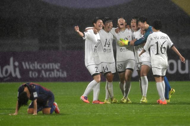 Naegohyang Women's FC players celebrate their victory after the AFC Women's Champions League semi-final football match between North Korea's Naegohyang Women's FC and South Korea's Suwon FC Women in Suwon on May 20, 2026. (Photo by Jung Yeon-je / AFP)