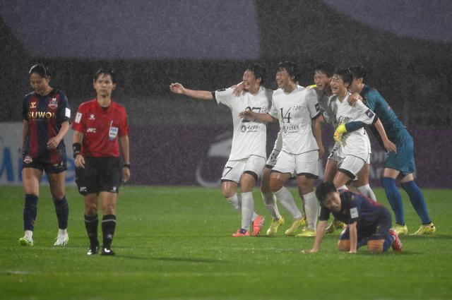 Naegohyang Women's FC players celebrate their victory after the AFC Women's Champions League semi-final football match between North Korea's Naegohyang Women's FC and South Korea's Suwon FC Women in Suwon on May 20, 2026. (Photo by Jung Yeon-je / AFP)