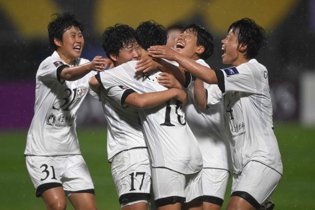Kim Kyong Yong (2nd L #17) of Naegohyang Women's FC celebrates scoring her team's second goal with teammates during the AFC Women's Champions League semi-final football match between North Korea's Naegohyang Women's FC and South Korea's Suwon FC Women in Suwon on May 20, 2026. (Photo by Jung Yeon-je / AFP)