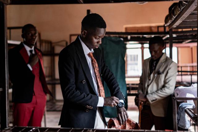 Senior year students at St. Julian High School get ready and dress up before attending their prom party themed “A Night in Italy” in Gayaza, on May 19, 2026. Uganda’s high school proms, influenced by global youth and celebrity culture and amplified by social media, have become lavish celebrations blending fashion, creativity and status with local styles of celebration. Mostly seen in elite and urban schools, the events feature themed decor, luxury arrivals and elaborate outfits, with some students previously making headlines for arriving by helicopter before the government banned helicopters and luxury SUV's at school events. Schools balance student expression and modern trends with cultural values and stricter government regulations. (Photo by Badru Katumba / AFP)