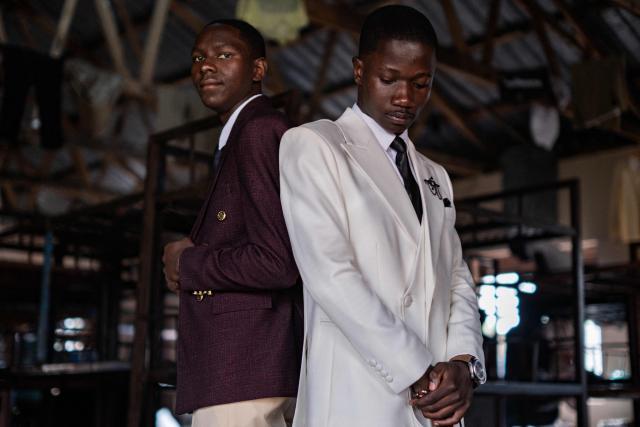 Senior year students at St. Julian High School pose for a picture inside their dormitory after dressing up to attend their prom party themed “A Night in Italy” in Gayaza, on May 19, 2026. Uganda’s high school proms, influenced by global youth and celebrity culture and amplified by social media, have become lavish celebrations blending fashion, creativity and status with local styles of celebration. Mostly seen in elite and urban schools, the events feature themed decor, luxury arrivals and elaborate outfits, with some students previously making headlines for arriving by helicopter before the government banned helicopters and luxury SUV's at school events. Schools balance student expression and modern trends with cultural values and stricter government regulations. (Photo by Badru Katumba / AFP)