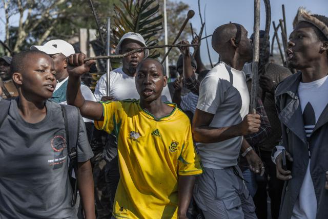 TOPSHOT - Members of “March and March” sings and chants anti-migrant slogans during a protest march in Durban on May 20, 2026. The group calls for stronger action against illegal immigration and the deportation of undocumented foreign nationals. The protest takes place amid rising public concern over border control, law enforcement, and the government’s national policy. (Photo by RAJESH JANTILAL / AFP)