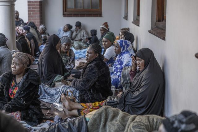 TOPSHOT - Foreign nationals continue to gather at the Diakonia Centre, saying they have no safe place to return to and are appealing for help from the South African government and several Non-Governmental Organizations (NGOs) in Durban on May 20, 2026. The crowd, made up largely of refugees and foreign nationals had been sheltering at the station for up to two days, seeking police protection amid threats and intimidation. Their presence came against the backdrop of sporadic anti-illegal immigration protests that have unsettled parts of South Africa in recent weeks. (Photo by RAJESH JANTILAL / AFP)