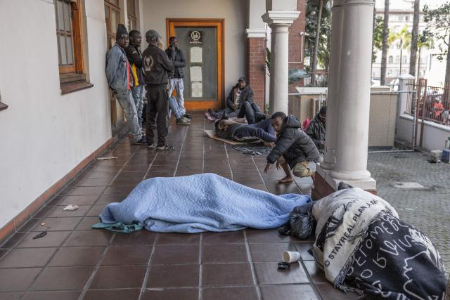 Foreign nationals continue to gather at the Diakonia Centre, saying they have no safe place to return to and are appealing for help from the South African government and several Non-Governmental Organizations in Durban on May 20, 2026. The crowd, made up largely of refugees and foreign nationals had been sheltering at the station for up to two days, seeking police protection amid threats and intimidation. Their presence came against the backdrop of sporadic anti-illegal immigration protests that have unsettled parts of South Africa in recent weeks. (Photo by RAJESH JANTILAL / AFP)
