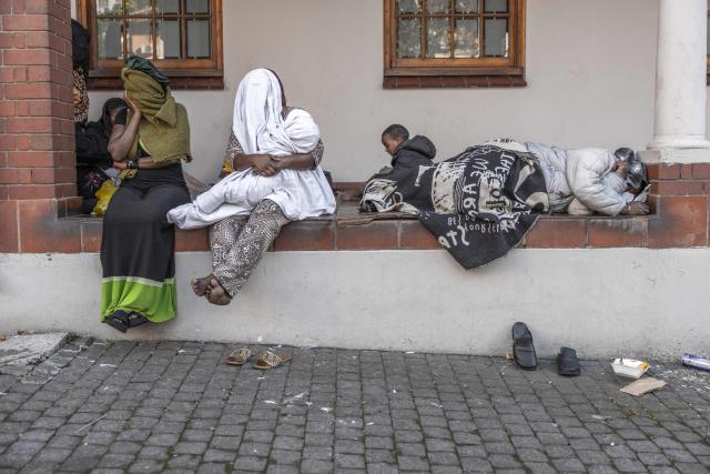 Foreign nationals continue to gather at the Diakonia Centre, saying they have no safe place to return to and are appealing for help from the South African government and several Non-Governmental Organizations (NGOs) in Durban on May 20, 2026. The crowd, made up largely of refugees and foreign nationals had been sheltering at the station for up to two days, seeking police protection amid threats and intimidation. Their presence came against the backdrop of sporadic anti-illegal immigration protests that have unsettled parts of South Africa in recent weeks. (Photo by RAJESH JANTILAL / AFP)