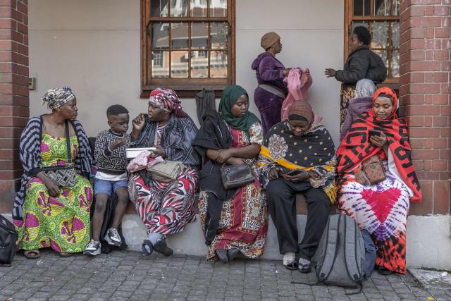 Foreign nationals continue to gather at the Diakonia Centre, saying they have no safe place to return to and are appealing for help from the South African government and several Non-Governmental Organizations in Durban on May 20, 2026. The crowd, made up largely of refugees and foreign nationals had been sheltering at the station for up to two days, seeking police protection amid threats and intimidation. Their presence came against the backdrop of sporadic anti-illegal immigration protests that have unsettled parts of South Africa in recent weeks. (Photo by RAJESH JANTILAL / AFP)