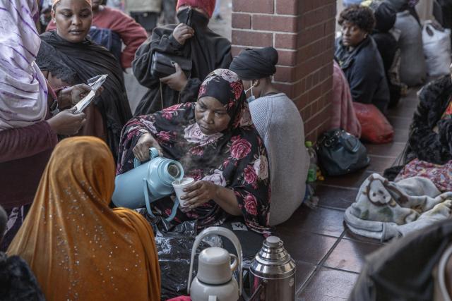 Foreign nationals continue to gather at the Diakonia Centre, saying they have no safe place to return to and are appealing for help from the South African government and several Non-Governmental Organizations (NGOs) in Durban on May 20, 2026. The crowd, made up largely of refugees and foreign nationals had been sheltering at the station for up to two days, seeking police protection amid threats and intimidation. Their presence came against the backdrop of sporadic anti-illegal immigration protests that have unsettled parts of South Africa in recent weeks. (Photo by RAJESH JANTILAL / AFP)