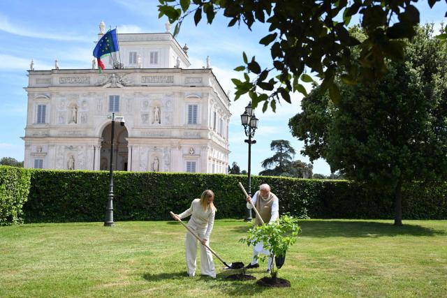 Italian Prime Minister Giorgia Meloni (L) plants a tree with Indian Prime Minister Narendra Modi (R) at Villa Doria Pamphili in Rome on May 20, 2026, as the two leaders hold bilateral talks focusing on strengthening India-Italy cooperation. (Photo by Alberto PIZZOLI / AFP)
