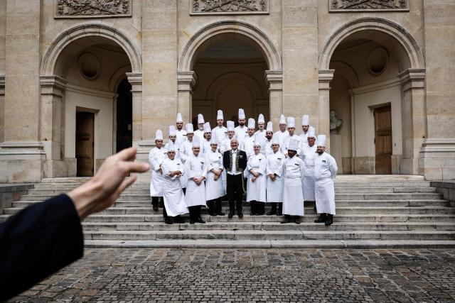 French chef Guy Savoy (C) and his team pose for a family picture before his investiture ceremony at the Académie des Beaux-Arts in Paris, on May 20, 2026. (Photo by SIMON WOHLFAHRT / AFP)