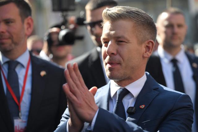 Hungary's Prime Minister Peter Magyar gestures to suppoerters upon arrival for a meeting with former leader of Solidarnosc and former President of Poland Lech Walesa (unseen) in Gdansk, Poland, on May 20, 2026. Hungary's new Prime Minister Peter Magyar is on a two-day visit to Poland for his first official trip abroad, hoping to mark his country's re-alignment with the European Union after years of open conflict under his predecessor. (Photo by Sergei GAPON / AFP)