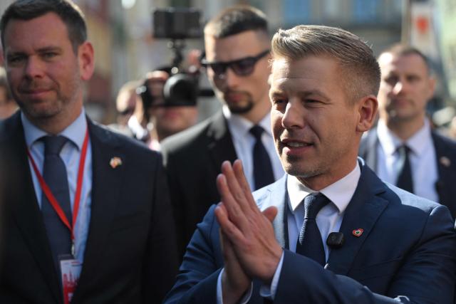 Hungary's Prime Minister Peter Magyar gestures to supporters upon arrival for a meeting with former leader of Solidarnosc and former President of Poland Lech Walesa (unseen) in Gdansk, Poland, on May 20, 2026. Hungary's new Prime Minister Peter Magyar is on a two-day visit to Poland for his first official trip abroad, hoping to mark his country's re-alignment with the European Union after years of open conflict under his predecessor. (Photo by Sergei GAPON / AFP)
