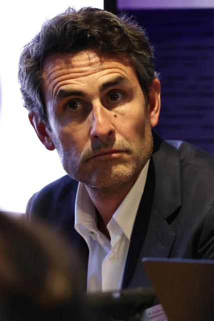 CEO of the Iliad Group Thomas Reynaud looks on during a press conference to announce the creation of a consortium to support the bid for an European AI Gigafactory in France, in Paris on May 20, 2026. Named “AION,” the consortium of 28 companies will submit a French proposal in response to a call for tenders from the European Commission, which is expected to be published shortly, with the aim of creating in Europe a handful of mega computing infrastructure projects that are essential for the development of AI. (Photo by Anne-Christine POUJOULAT / AFP)