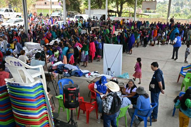 Nahua indigenous women wait in line to receive humanitaria aid in Alcozacan, a community affected by drug-related violence, in Guerero state, Mexico, on May 19, 2026 (Photo by YURI CORTEZ / AFP)