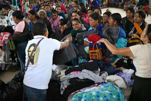Nahua indigenous women receive humanitaria aid in Alcozacan, a community affected by drug-related violence, in Guerero state, Mexico, on May 19, 2026 (Photo by YURI CORTEZ / AFP)