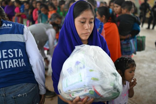 A Nahua indigenous youngster leaves after receiving humanitaria aid in Alcozacan, a community affected by drug-related violence, in Guerero state, Mexico, on May 19, 2026 (Photo by YURI CORTEZ / AFP)