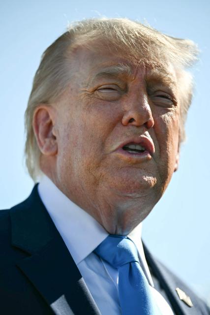 US President Donald Trump speaks to reporters before boarding Air Force One at Joint Base Andrews, Maryland on May 20, 2026. Trump is heading to New London, Connecticut, to deliver the commencement address to the US Coast Guard Academy's 2026 graduating class. (Photo by Kent NISHIMURA / AFP)
