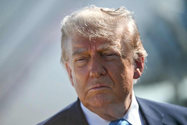 US President Donald Trump speaks to reporters before boarding Air Force One at Joint Base Andrews, Maryland on May 20, 2026. Trump is heading to New London, Connecticut, to deliver the commencement address to the US Coast Guard Academy's 2026 graduating class. (Photo by Kent NISHIMURA / AFP)