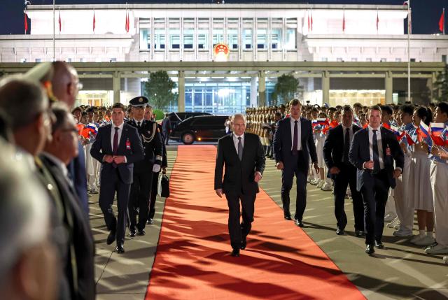 In this pool photograph distributed by the Russian state agency Sputnik, Russia's President Vladimir Putin walks at Beijing Capital Airport as he departs Beijing on May 20, 2026, after a two-day visit. (Photo by Alexander KAZAKOV / POOL / AFP)