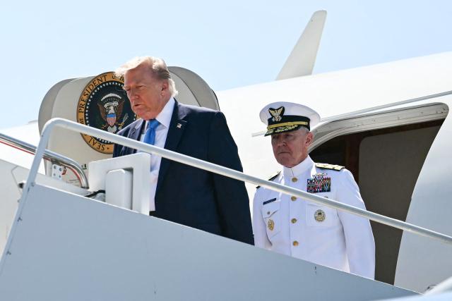 (L/R) US President Donald Trump and US Coast Guard Commandant Admiral Kevin E. Lunday step off Air Force One upon arrival at Groton–New London Airport in Groton, Connecticut, on May 20, 2026. Trump is heading to New London to deliver the keynote speech to the US Coast Guard Academy's 2026 graduating class. (Photo by Kent NISHIMURA / AFP)