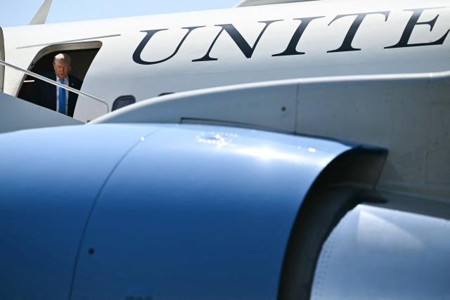 US President Donald Trump steps off Air Force One upon arrival at Groton–New London Airport in Groton, Connecticut, on May 20, 2026. Trump is heading to New London to deliver the keynote speech to the US Coast Guard Academy's 2026 graduating class. (Photo by Kent NISHIMURA / AFP)