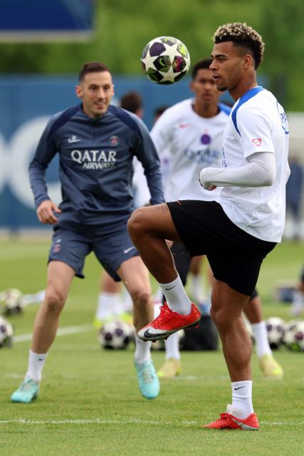 Paris Saint-Germain's French midfielder #14 Desire Doue practices during a training session ahead of their upcoming UEFA Champions League final match against English football club Arsenal FC at the PSG Campus in Poissy, north-west of Paris on May 20, 2026. (Photo by FRANCK FIFE / AFP)