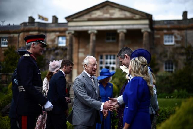 Britain's King Charles III (C) attends a garden party at Hillsborough Castle in Hillsborough, Northern Ireland on May 20, 2026, on the second day of a three-day royal visit to Northern Ireland. (Photo by Henry NICHOLLS / POOL / AFP)