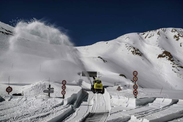 A worker drives a snowplough to clear snow from the Galibier Pass, a mountain road in the Dauphine Alps, above Valloire, eastern France, on May 20, 2026. (Photo by Jeff PACHOUD / AFP)