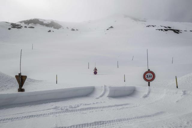 This photograph shows snow and road signs near the Galibier Pass, a mountain road partially cleared in the Dauphine Alps, above Valloire, eastern France, on May 20, 2026. (Photo by Jeff PACHOUD / AFP)
