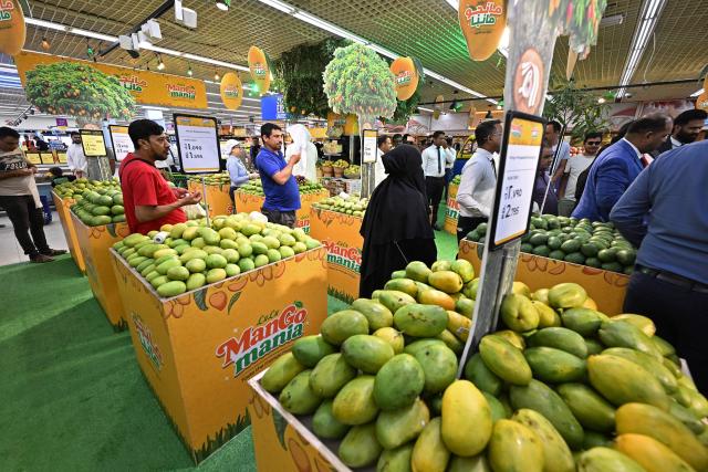 People shop for mangoes at a hypermarket during the Mango Mania Festival in Kuwait City on May 20, 2026. (Photo by YASSER AL-ZAYYAT / AFP)