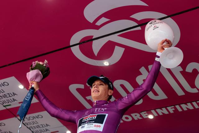 Soudal Quick-Step French rider Paul Magnier wearing the points classification mauve jersey (Maglia Ciclamino) poses on the podium after the 11th stage of the Giro d'Italia 2026 - Tour of Italy cycling race between Porcari and Chiavari, Italy, on May 20, 2026. (Photo by Luca Bettini / AFP)