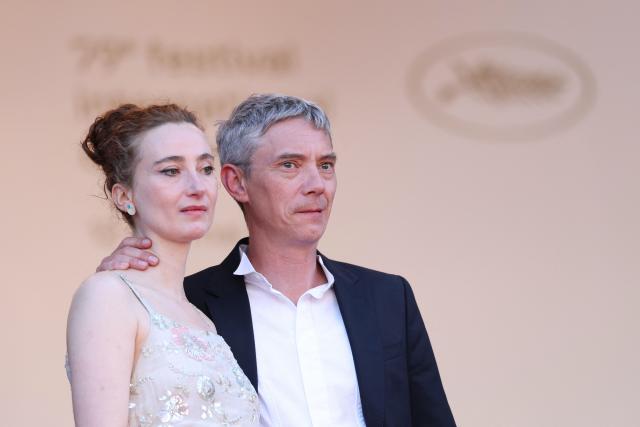 Belgian actress Sandrine Blancke and French actor Swann Arlaud leave after the screening of the film "Notre Salut" (A Man of His Time) at the 79th edition of the Cannes Film Festival in Cannes, southern France on May 20, 2026. (Photo by Sameer AL-DOUMY / AFP)