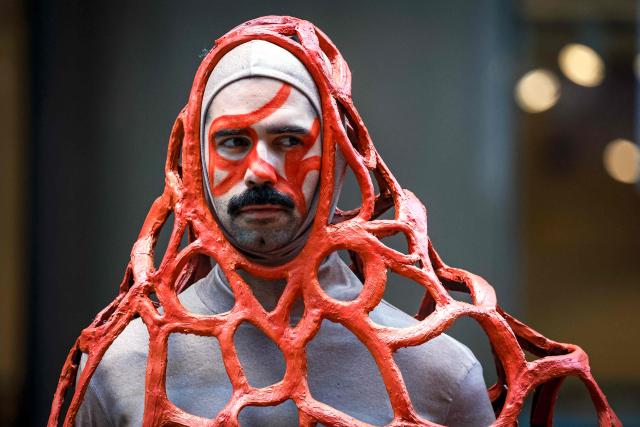 A performer wears a coral reef-inspired costume during a show to raise awareness of threats to Australia's Great Barrier Reef in Sydney on May 21, 2026. (Photo by DAVID GRAY / AFP)