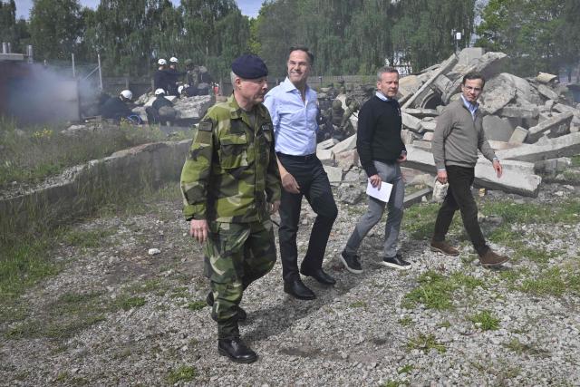 Sweden's Prime Minister Ulf Kristersson (R), NATO Secretary General Mark Rutte (2nd L), Lieutenant General Carl-Johan Edström (L), Chief of the Swedish Armed Forces Operations Command, and Mikael Frisell (2nd R), Director General of the Swedish Civil Defence Agency, visit the Swedish Civil Defence Agency in Revinge, Sweden, on May 21, 2026, where they were presented various exercises of military and civil defence working together in the case of bomb and missile attacks. (Photo by Johan Nilsson/TT / TT News Agency / AFP) / Sweden OUT