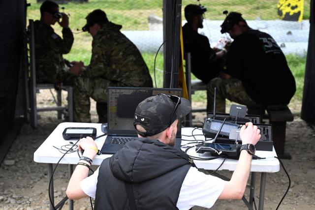 Ukrainian servicemen competes in the “Wild Drones” racing competition — designed to simulate battlefield conditions — in Truskavets, Lviv region, on May 20, 2026, amid Russia’s invasion of Ukraine. (Photo by YURIY DYACHYSHYN / AFP)