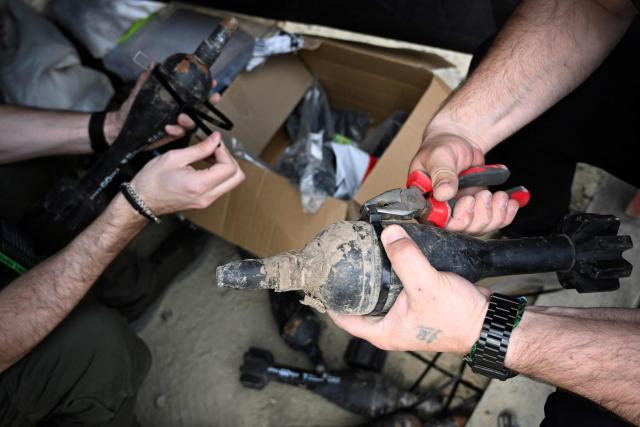 Technicians prepare dummy explosives during the “Wild Drones” racing competition — designed to simulate battlefield conditions — in Truskavets, Lviv region, on May 20, 2026, amid Russia’s invasion of Ukraine. (Photo by YURIY DYACHYSHYN / AFP)