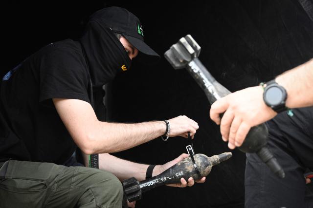 Technicians prepare dummy explosives during the “Wild Drones” racing competition — designed to simulate battlefield conditions — in Truskavets, Lviv region, on May 20, 2026, amid Russia’s invasion of Ukraine. (Photo by YURIY DYACHYSHYN / AFP)
