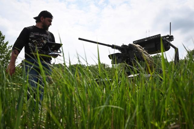 A man pilots an unmanned ground vehicle (UGV)  during the “Wild Drones” racing competition — designed to simulate battlefield conditions — in Truskavets, Lviv region, on May 20, 2026, amid Russia’s invasion of Ukraine. (Photo by YURIY DYACHYSHYN / AFP)