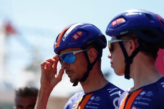 Team Picnic PostNL French rider Warren Barguil (L) looks on as he prepares to compete in the 12th stage of the Giro d'Italia 2026 - Tour of Italy cycling race between Imperia and Novi Ligure, Italy, on May 21, 2026. (Photo by Luca Bettini / AFP)