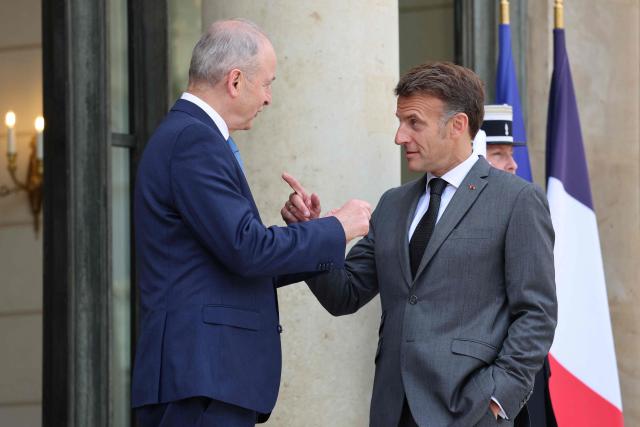 France's President Emmanuel Macron (R) welcomes Ireland's Prime Minister Micheal Martin upon his arrival and ahead of their meeting at the Elysee Presidential Palace in Paris on May 21, 2026. (Photo by Ludovic MARIN / AFP)