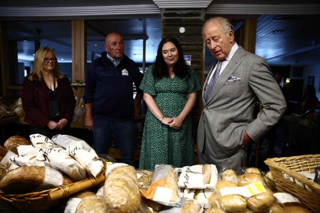 Britain's King Charles III reacts as he looks at locally produced goods during a visit to The Warehouse, in Newtownards, Northern Ireland on May 21, 2026, on the final day of a three-day royal visit to Northern Ireland. Housed in a former pub, The Warehouse has been transformed into a lively and welcoming community hub, offering vital support through free food supplies, hot and take-home meals, skills classes, and access to free clothing and household essentials. (Photo by Henry NICHOLLS / POOL / AFP)