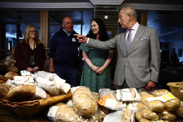 Britain's King Charles III reacts as he looks at locally produced goods during a visit to The Warehouse, in Newtownards, Northern Ireland on May 21, 2026, on the final day of a three-day royal visit to Northern Ireland. Housed in a former pub, The Warehouse has been transformed into a lively and welcoming community hub, offering vital support through free food supplies, hot and take-home meals, skills classes, and access to free clothing and household essentials. (Photo by Henry NICHOLLS / POOL / AFP)
