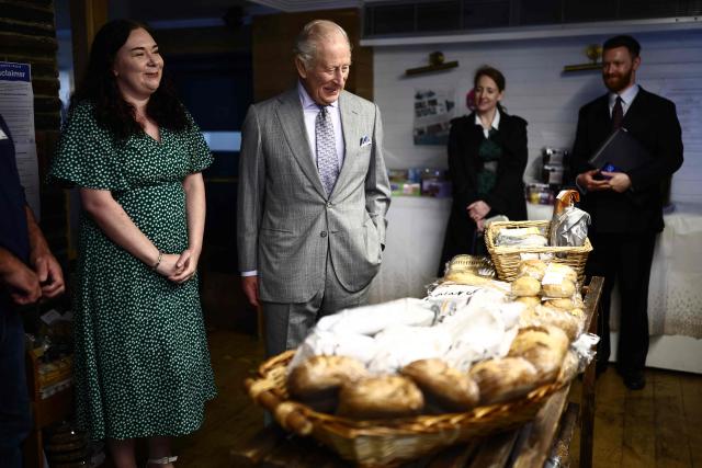 Britain's King Charles III reacts as he looks at locally produced goods during a visit to The Warehouse, in Newtownards, Northern Ireland on May 21, 2026, on the final day of a three-day royal visit to Northern Ireland. Housed in a former pub, The Warehouse has been transformed into a lively and welcoming community hub, offering vital support through free food supplies, hot and take-home meals, skills classes, and access to free clothing and household essentials. (Photo by Henry NICHOLLS / POOL / AFP)