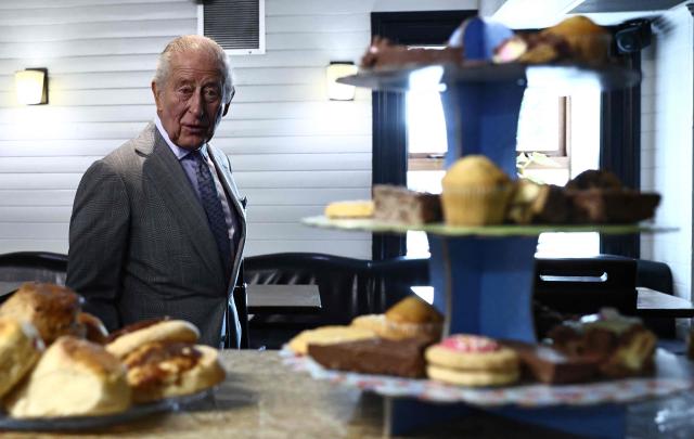Britain's King Charles III reacts as he looks at locally produced goods during a visit to The Warehouse, in Newtownards, Northern Ireland on May 21, 2026, on the final day of a three-day royal visit to Northern Ireland. Housed in a former pub, The Warehouse has been transformed into a lively and welcoming community hub, offering vital support through free food supplies, hot and take-home meals, skills classes, and access to free clothing and household essentials. (Photo by Henry NICHOLLS / POOL / AFP)