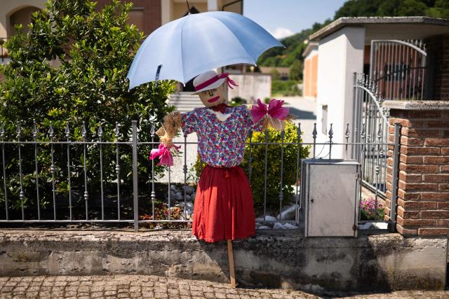 A scarecrow is displayed during a "Scarecrows Fair" in Castellar, near Cuneo, northern Italy on May 21, 2026.  During the annual fair, citizens prepare their own scarecrow and put them in the gardens, courtyards, fields and streets. (Photo by MARCO BERTORELLO / AFP)