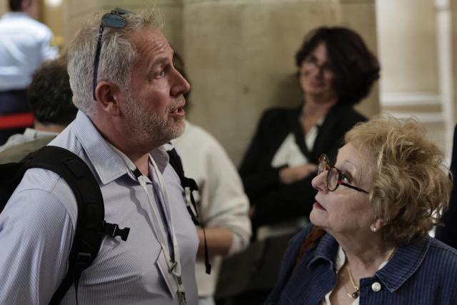 Teddy Robert (L), brother of flight AF447's co-pilot, and Daniele Lamy (R), president of victims' families association Entraide et Solidarite AF447, stand outside the courthouse on Ile de la Cite in Paris ahead of the verdict in the trial of Airbus and Air France on charges of manslaughter in connection with the 2009 Rio-Paris flight crash, on May 21, 2026. (Photo by STEPHANE DE SAKUTIN / AFP)