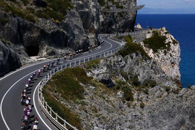 The pack rides at Noli Cape during the 12th stage of the Giro d'Italia 2026 - Tour of Italy cycling race between Imperia and Novi Ligure, Italy, on May 21, 2026. (Photo by Luca Bettini / AFP)