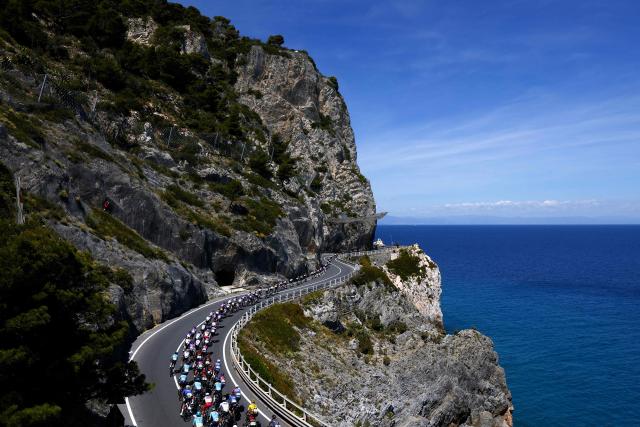 The pack rides at Noli Cape during the 12th stage of the Giro d'Italia 2026 - Tour of Italy cycling race between Imperia and Novi Ligure, Italy, on May 21, 2026. (Photo by Luca Bettini / AFP)