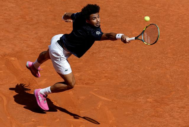 (FILES) France's Arthur Fils returns the ball to Italy's Jannik Sinner during their 2026 ATP Tour Madrid Open tennis tournament semi-final singles match at the Caja Magica in Madrid, on May 1, 2026. France’s No. 1 Arthur Fils (world No. 19) will face Switzerland’s Stan Wawrinka, the 2015 champion who is playing his final professional season at the age of 41, in the first round of Roland Garros (24 May – 7 June), according to the draw held in Paris on May 21, 2026. (Photo by OSCAR DEL POZO / AFP)